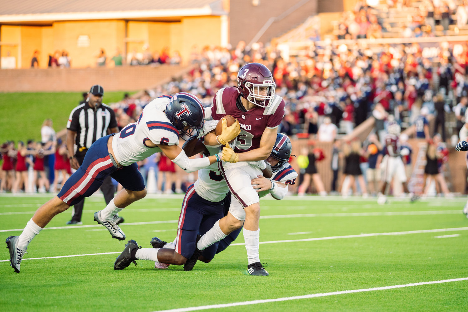 Cinco Ranch’s Seth Salverino fights for yardage after a catch during Friday’s game between Cinco Ranch and Tompkins at Rhodes Stadium.